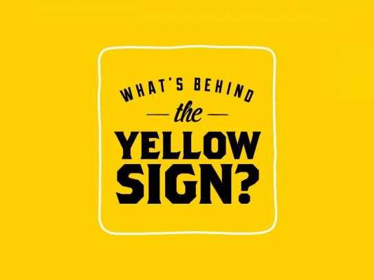 What's behind the yellow sign